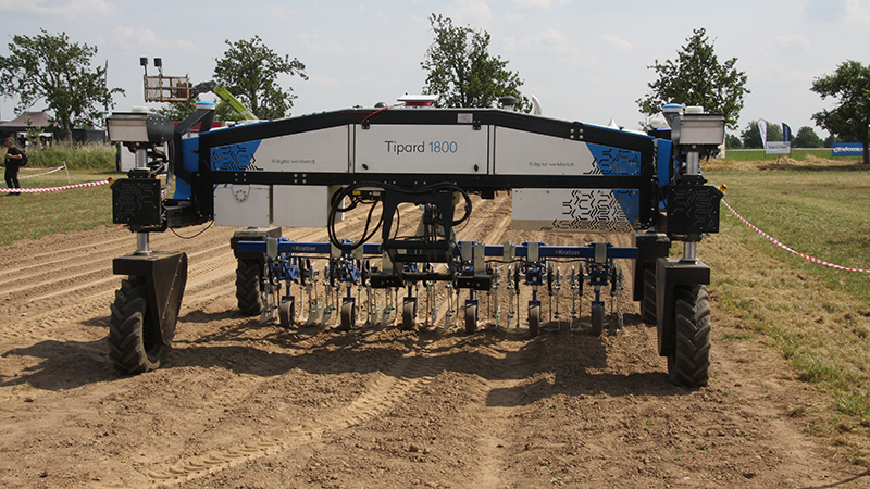Robotic gantry machine in arable field.