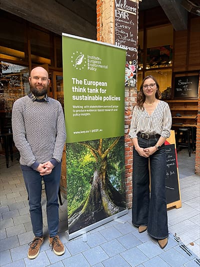 Christian Gossel and Christine de Visser stand by a banne for the IEEP