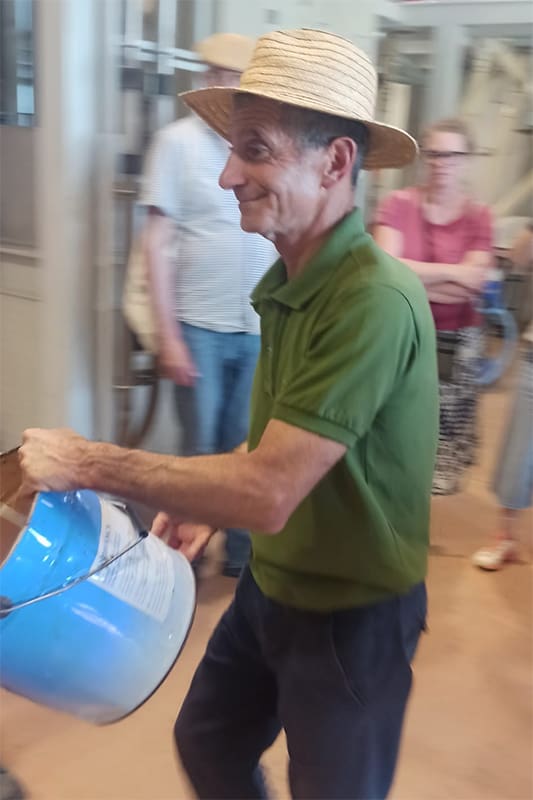 Man with bucket and hat