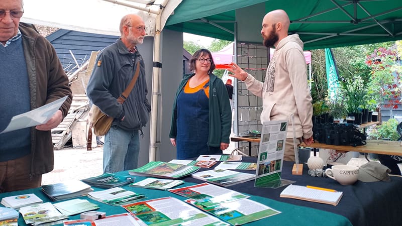 Christian Gossel talking with attendees at the Agroforestry Open Weekend at the ORC stall