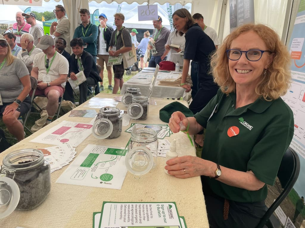 Julia Cooper standing by a table talking soils and compost