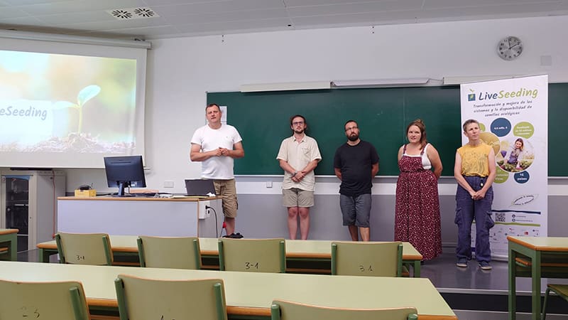 5 people stand at the front of a room